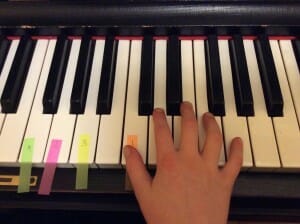 Maddie's hand on the keys to play 5ths