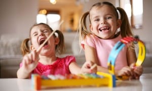 Two-Pre-schoolers-girls-playing with tambourines-and-drums