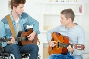 Two men amazed playing the guitar