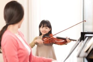 Sweet girls playing violin