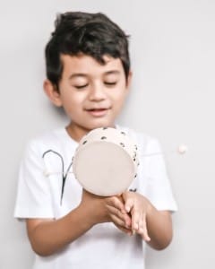 Little sweet boy, playing small drum, having fun