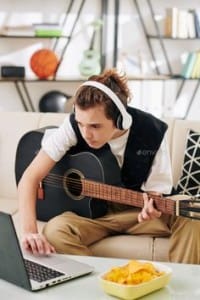 Teenager learning how to play the guitar, picture from Pinterest.