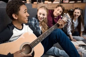Teenagers playing the guitar