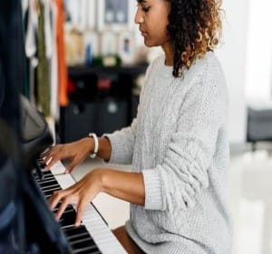 Delighted woman playing the piano